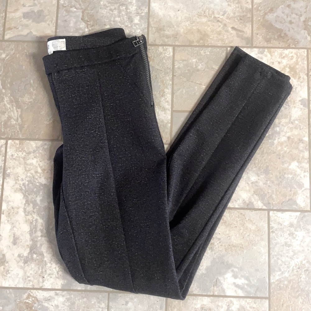 Black slacks, with silver zipper on side waist
